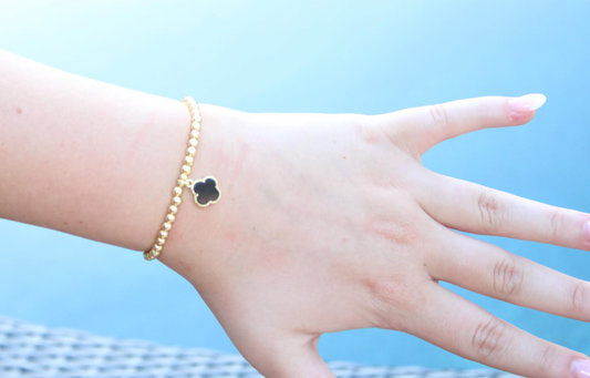 Gold Beaded Bracelet with Black Clover Charm